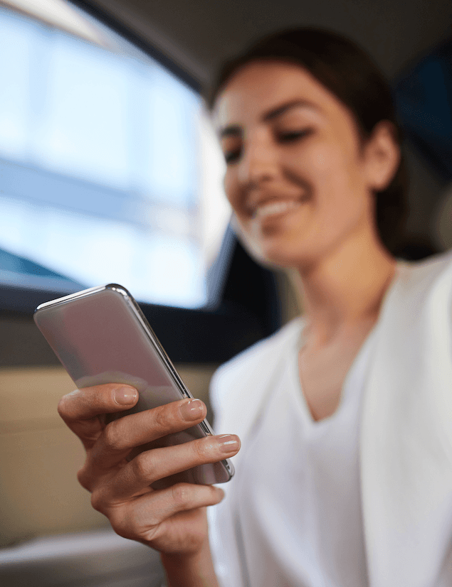 woman smiling at a mobile phone